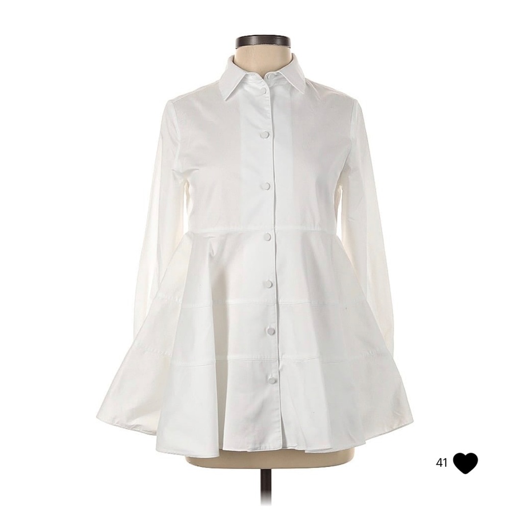 100% cotton long sleeve white top with high neck and a peplum silhouette.